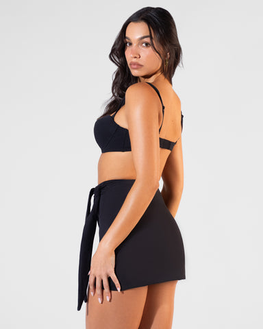 Back view of model wearing Mini Wrap Skirty - Black