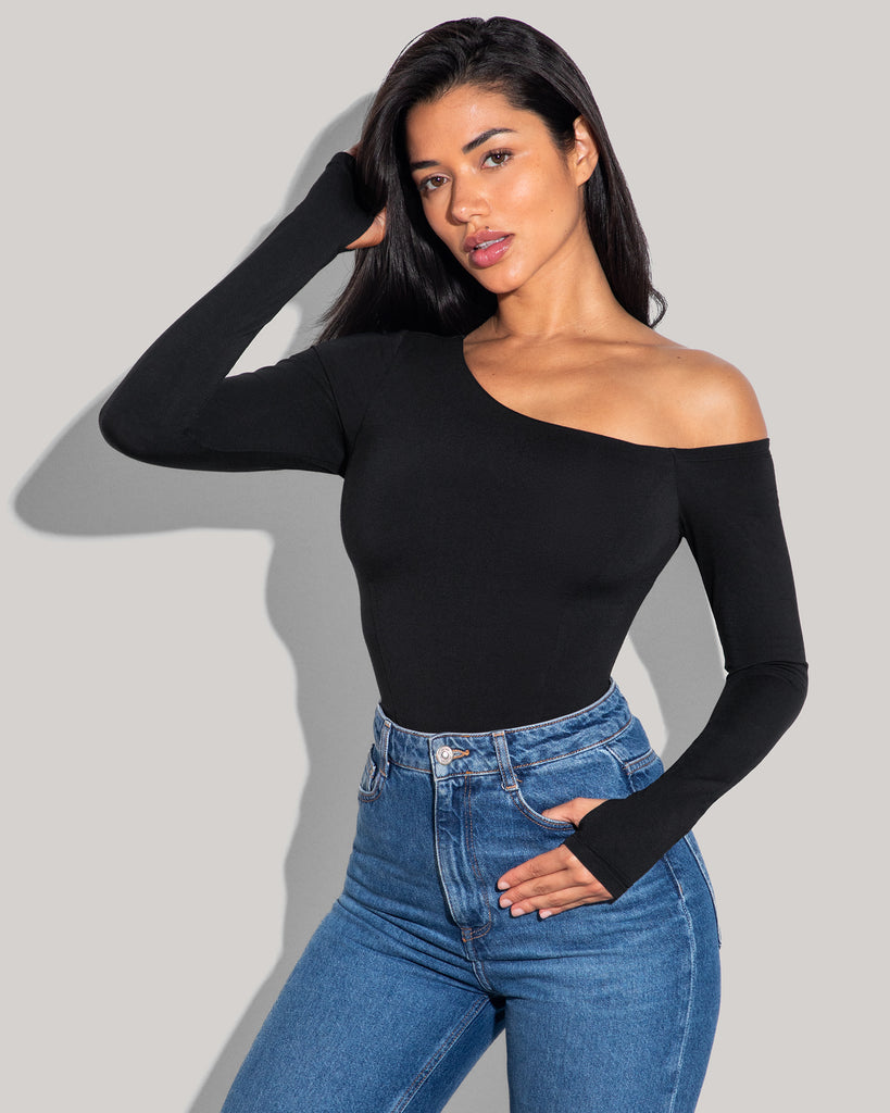 Model is posing in Shapey Long Sleeve One Shoulder Sculpting Shapewear Top - Black side view top is tucked in