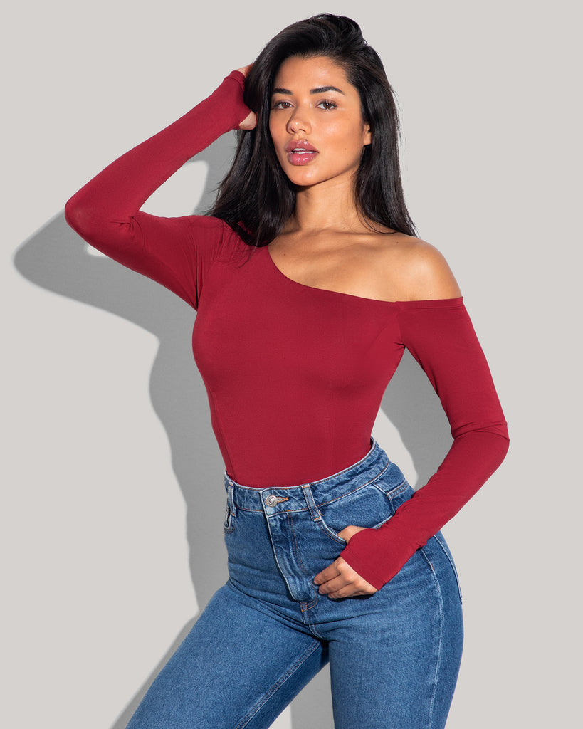 Model is posing in Shapey Long Sleeve One Shoulder Sculpting Shapewear Top - Ruby tucked in front view