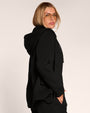 Side view of model wearing Swuity Convertible Jacket - Black