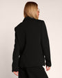Back view of model wearing Swuity Convertible Jacket - Black as a blazer