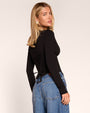 Three quarter back view of model wearing Corsety Long Sleeve Top - Black