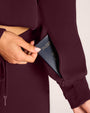 Close up of pocket on Convertible Fleecey - Garnet with a passport peeking out