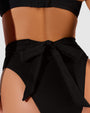 Close up back detail of Hi Cut Adjustable Kini Bottom - Black on model